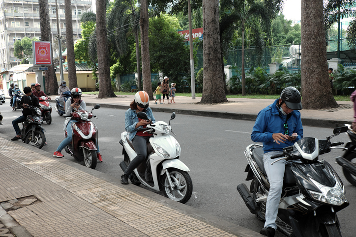 Vietnamese play pokemon go on motorbike