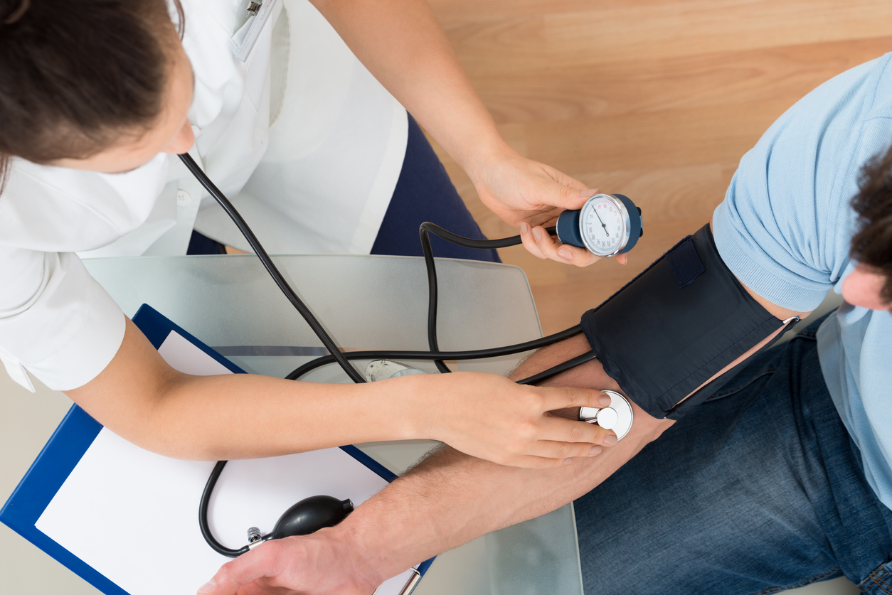 Doctor Measuring Blood Pressure Of Male Patient