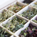 Different herbs in a wooden tea box