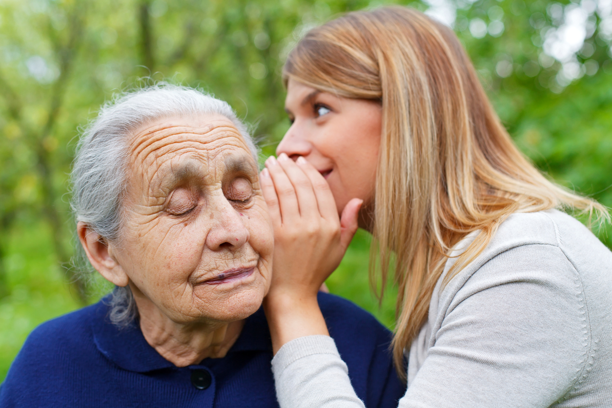 Whispering a secret to grandma's ear