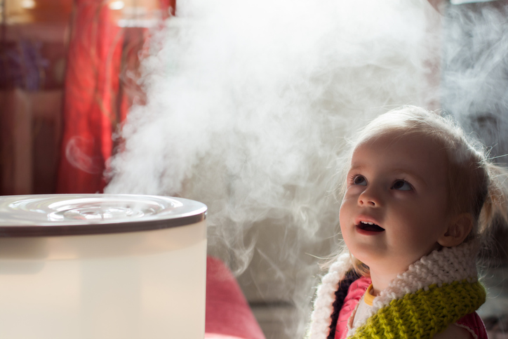 Baby girl mystifiied by a humidifier