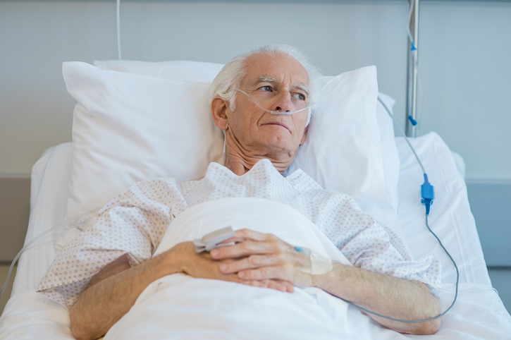 Old patient lying on bed