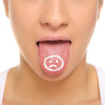 Women's tongue with sour face painted i
