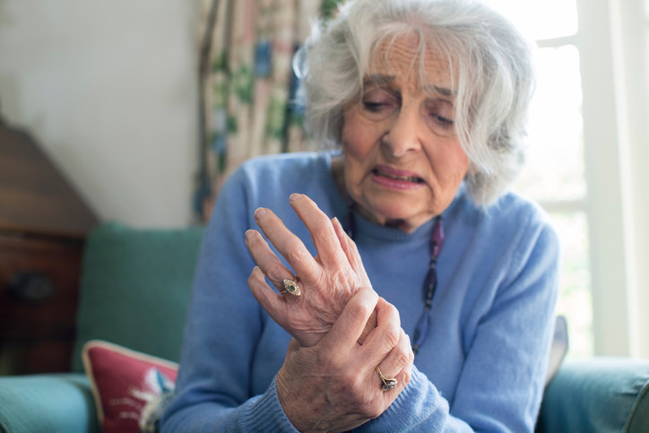 Senior Woman At Home Suffering With Arthritis