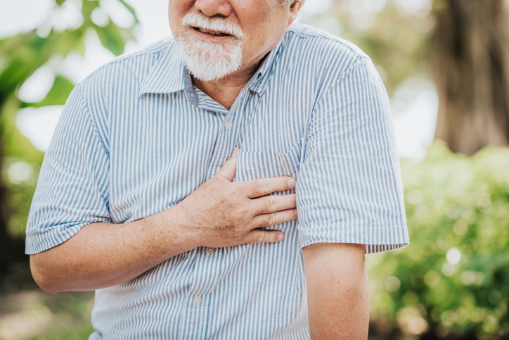 Senior man holding his chest and feeling pain