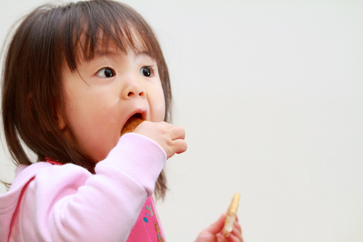 Japanese girl eating rice cracker