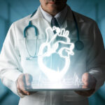 Doctor showing heart hologram from computer.