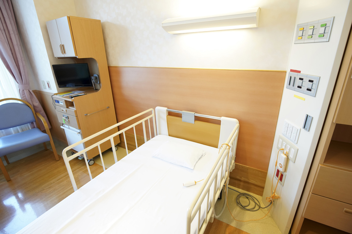 Hospital room with empty bed