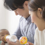 Japanese couple feeding baby milk from a bottle
