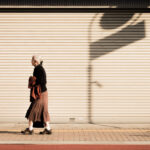 Aging population social issue of a widow lonely woman walking along the street of Japan