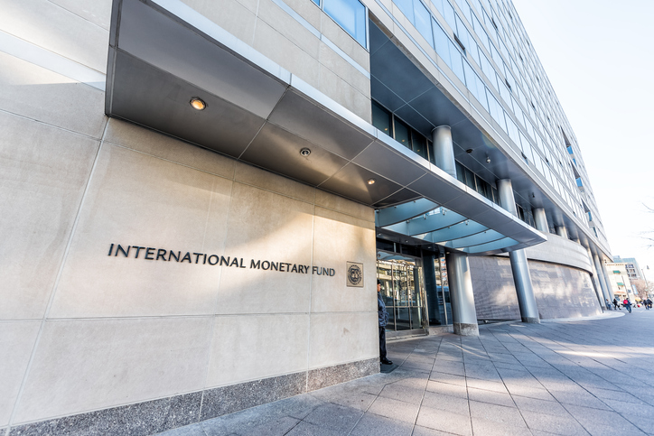 IMF entrance with sign of International Monetary Fund, concrete architecture building wall security guard doors