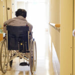 Back view of elderly woman sitting on wheelchair