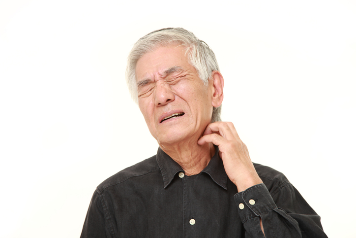 senior Japanese man scratching his neck