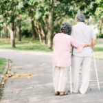 Senior couple talking a walk with walker