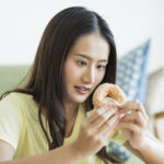 Young woman eating donut