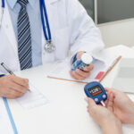 Doctor and patient diabetes consultation in office or clinic.