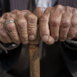 hand of a old man holding a cane