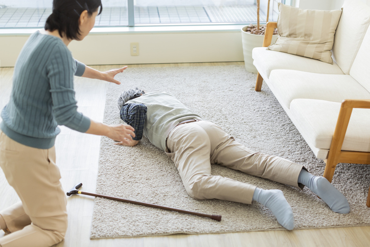 Woman who runs to a senior man who has fallen ill