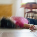Woman lying on the floor at home, epilepsy, unconsciousness, faint, stroke, accident or other health problem.