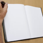 Senior Man Writes in Blank Journal