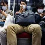 Tokyo commuters wearing facemasks on subway
