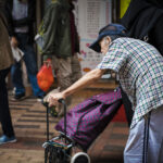 elder man walking the city streets of Hong Kong