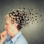 Senior woman losing parts of head feeling confused as symbol of decreased mind function.