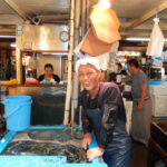 market seller in Tsukiji fish market Tokyo Japan