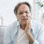 Old man with tooth sensitivity